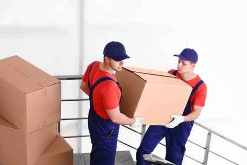 Careful unloading of household items at a Willesden property