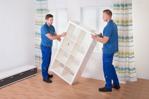 Dismantling office furniture before a move in Willesden